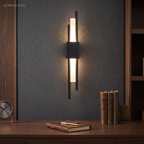 Black twin bar sconce lit on dark panelling above a sideboard