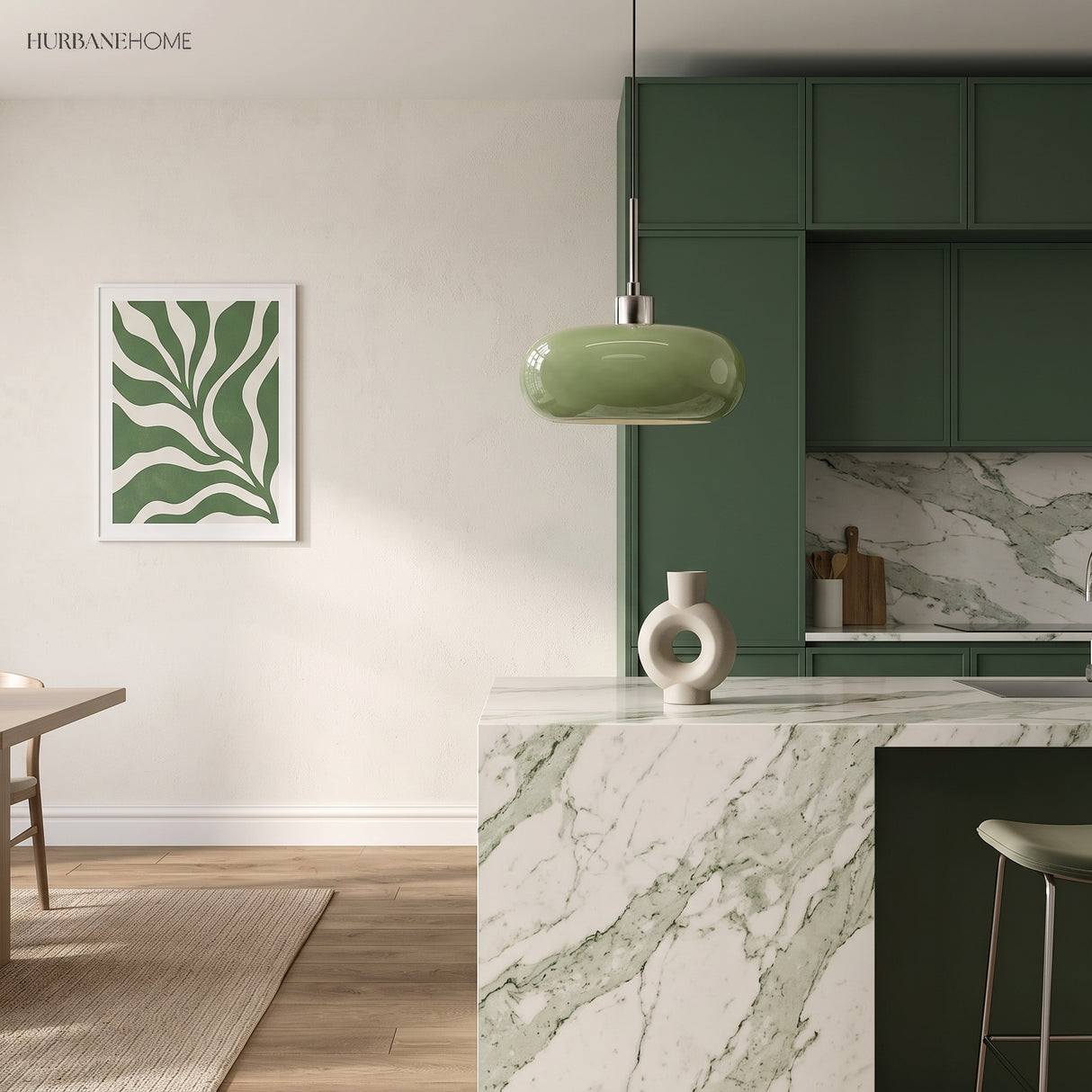Green glass pendant light in a green kitchen with marble counter