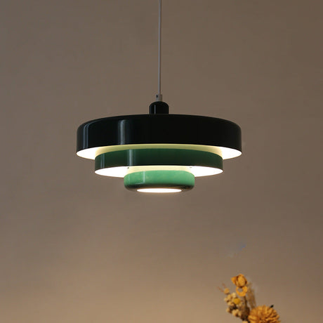 Black tiered pendant light with mint green inner rings, lit from within