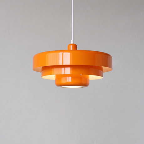 Orange mid century pendant light with three stepped metal tiers on a white cord