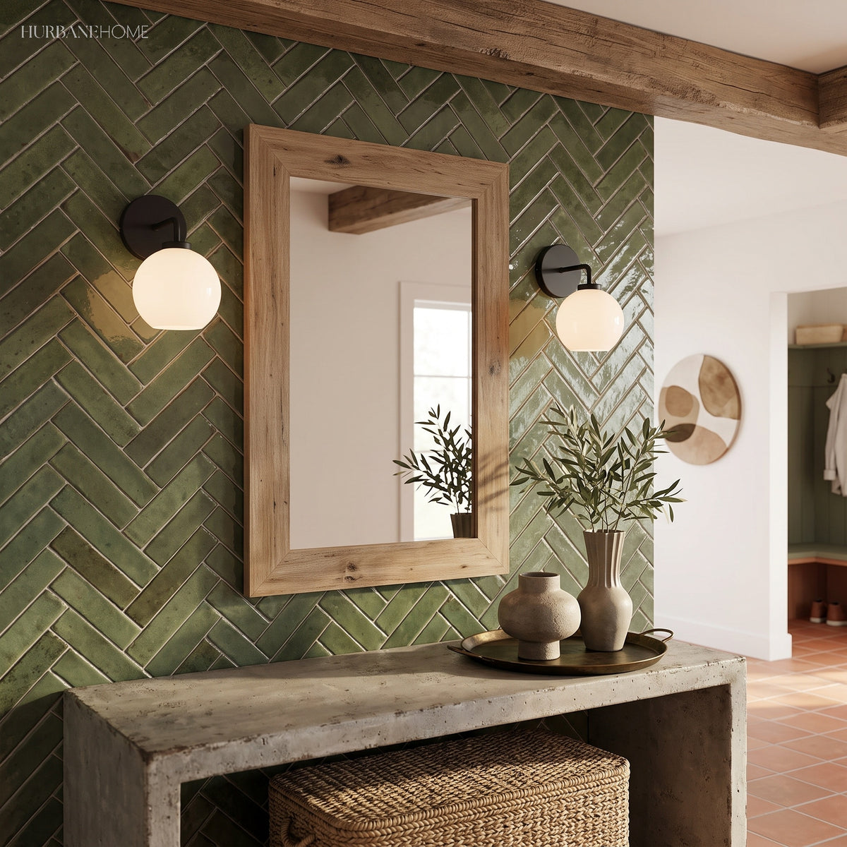 Pair of globe sconces flanking a timber mirror in a green tiled bathroom