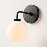 Milk glass globe wall sconce on metal arm alternative angle view 1