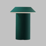Green cylindrical table with square top on a gray background