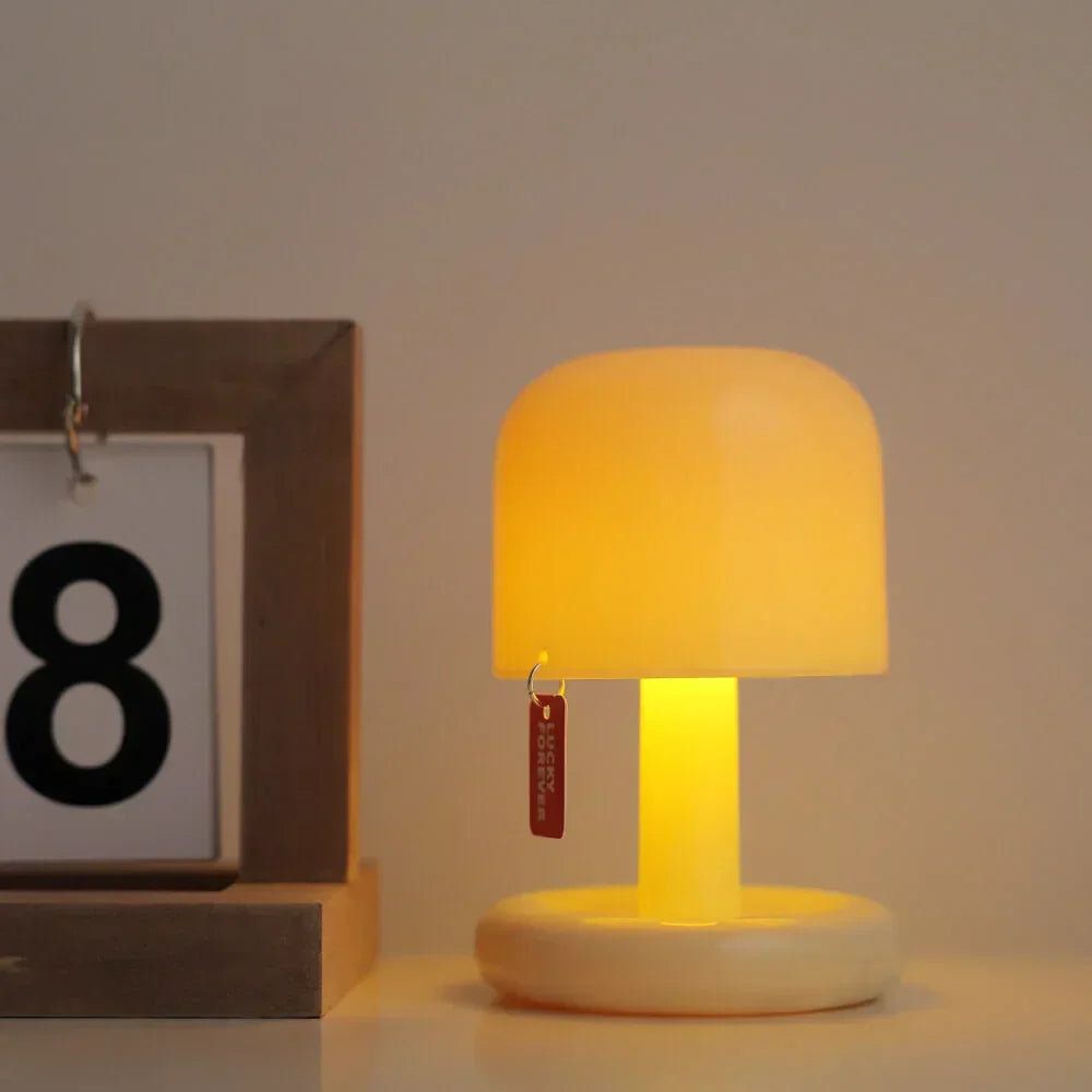 Mushroom mini lamp casting a warm glow next to a framed number card