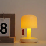 Mushroom mini lamp casting a warm glow next to a framed number card
