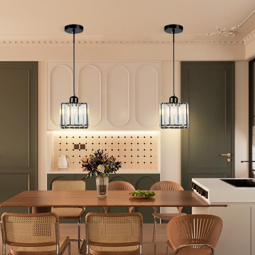 Pair of mini crystal pendants above a timber table in a green dining room