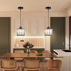 Pair of mini crystal pendants above a timber table in a green dining room