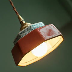 Close view of the glazed shade with the bulb lit beneath it