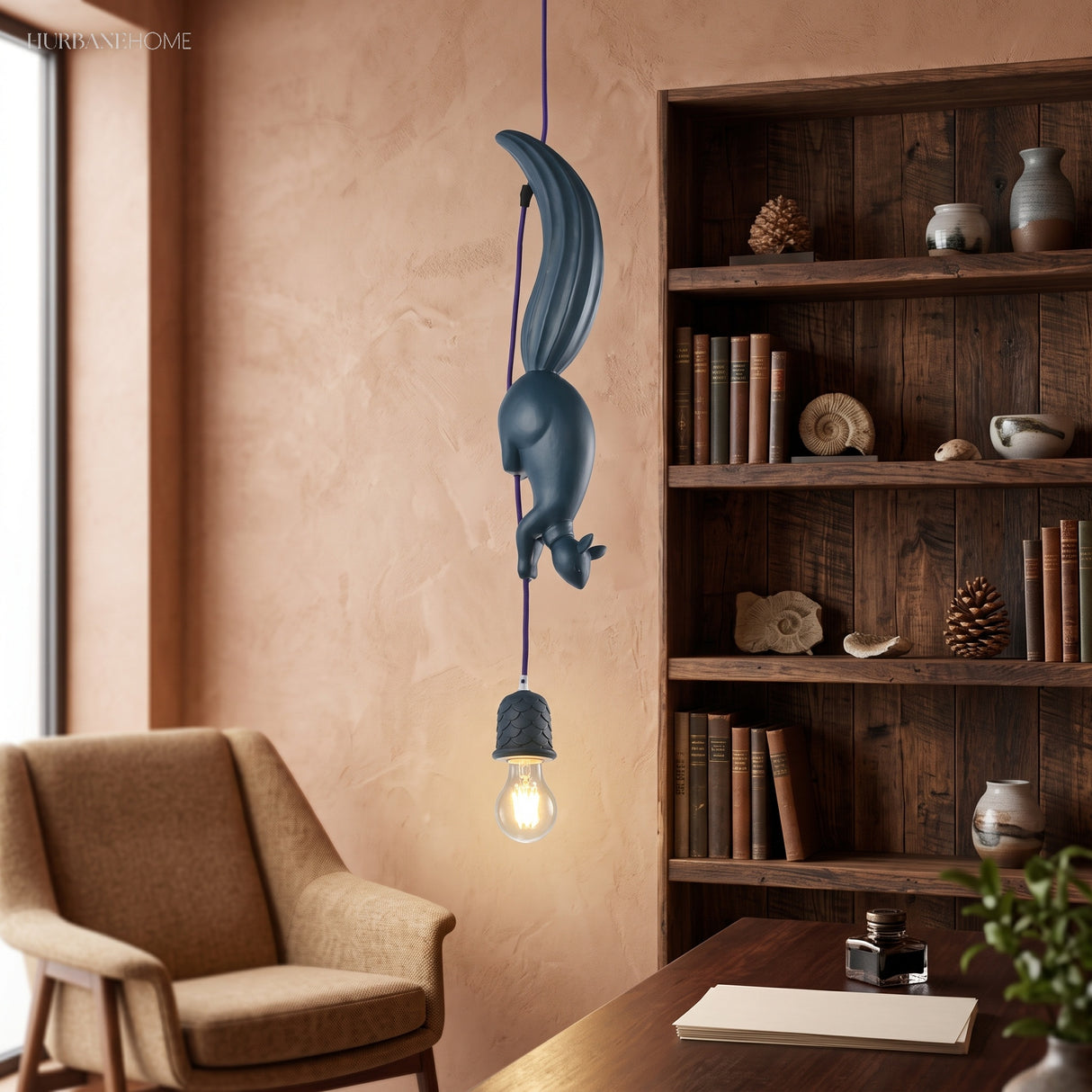 Blue squirrel pendant lit beside a bookcase and a leather chair