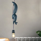 Two white squirrel pendants hung at different heights on grey
