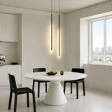 Minimalist cylinder pendant light hanging in a kitchen