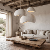 Grey minimalist pendant light cluster over a neutral living room sofa