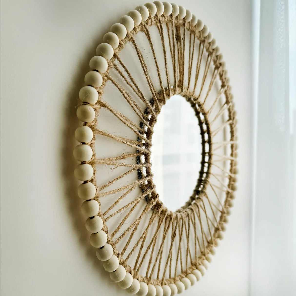 Minimalist round wall mirror styled in boho living room