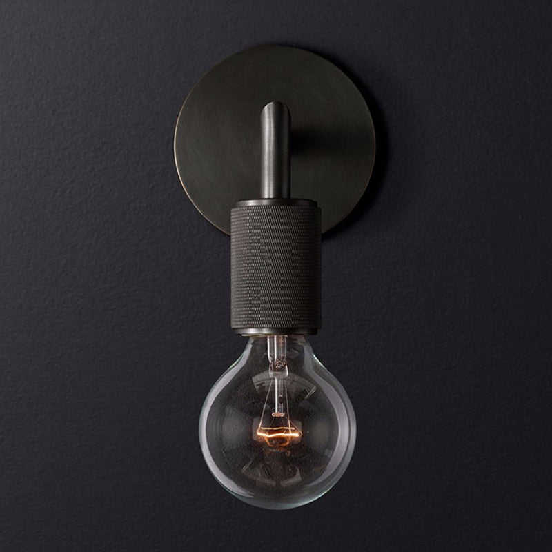 Black bare bulb sconce photographed straight on against charcoal