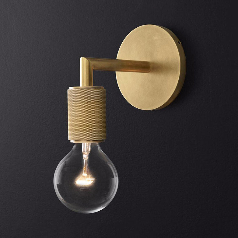 Angled view of the brass sconce showing its round backplate