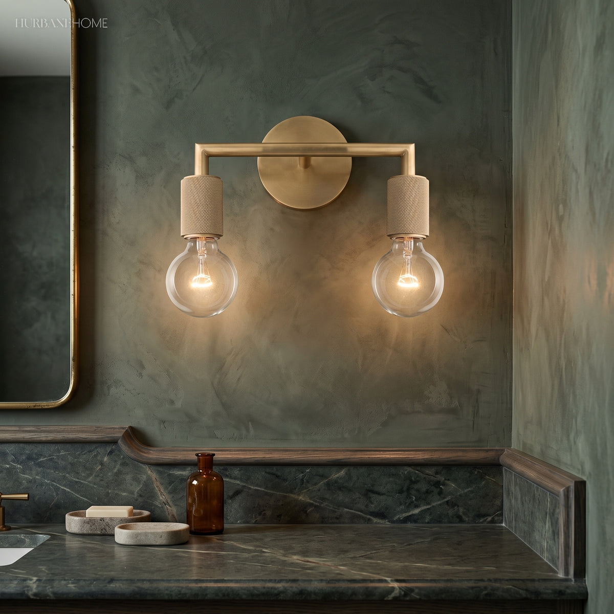 Two light brass sconce above a marble console and a wall mirror