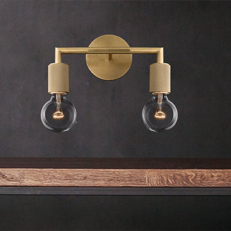 Two light brass sconce lit warm above a floating timber shelf