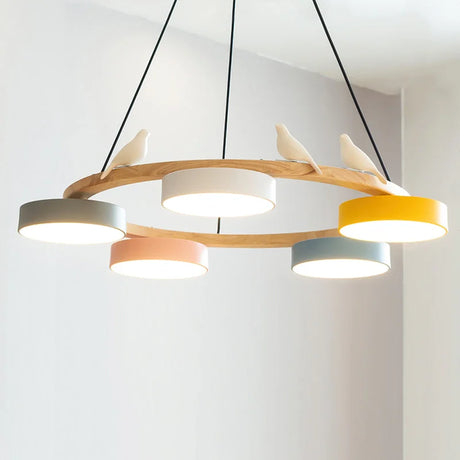 Bird chandelier lit with warm integrated LED showing the natural wood ring frame