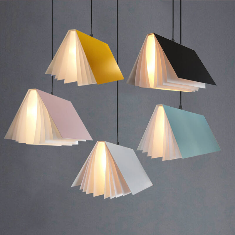 Five open book metal pendant shades against a grey background