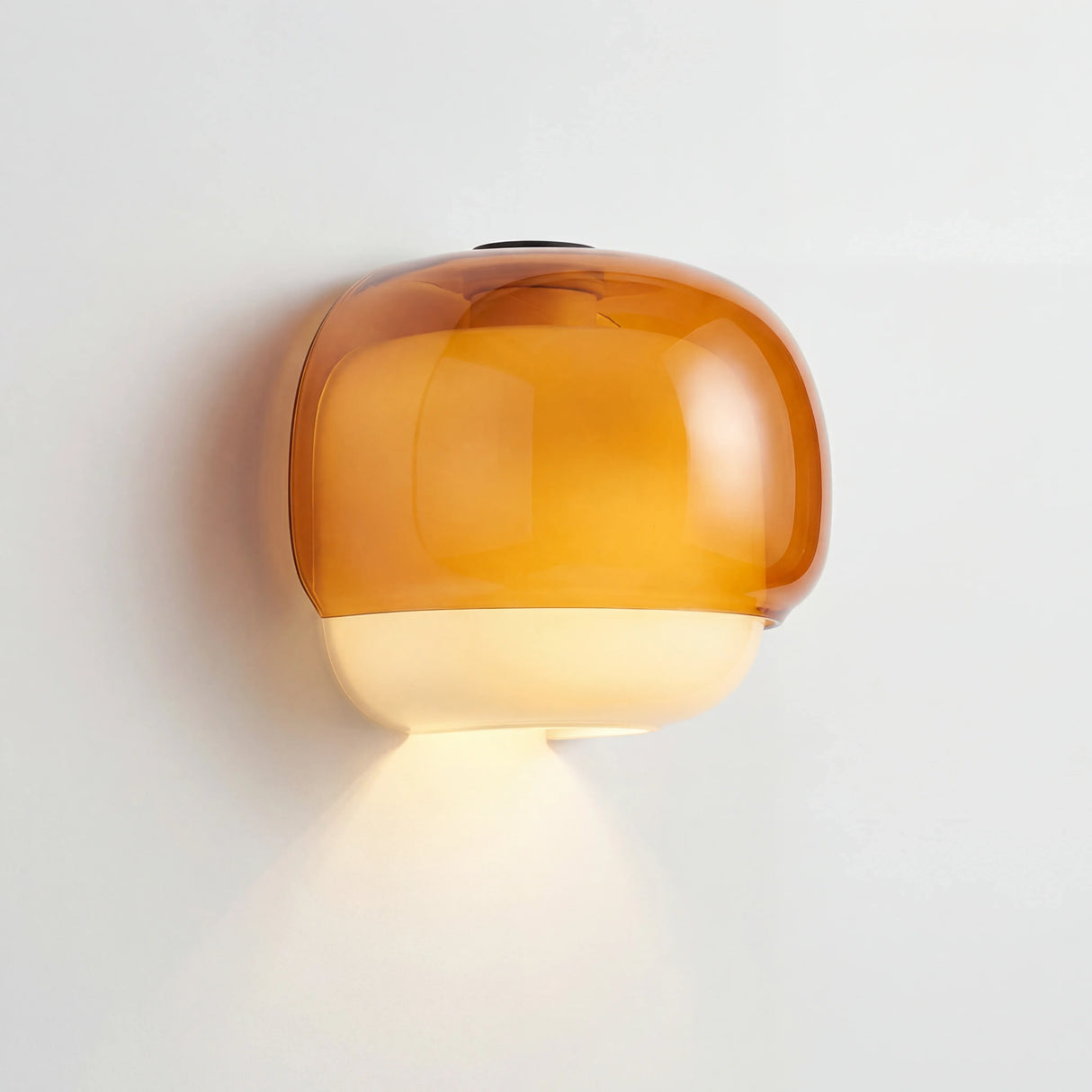 Amber two-tone glass wall sconce shown as a product studio image