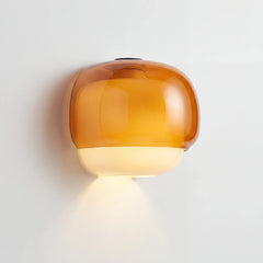 Amber two-tone glass wall sconce shown as a product studio image
