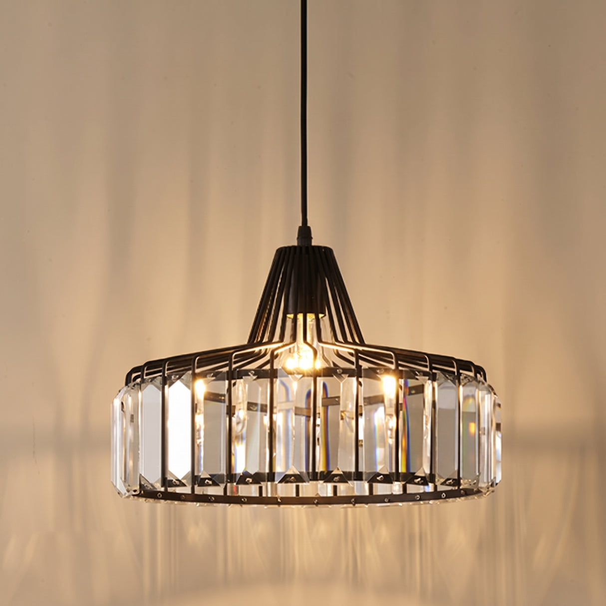 Black iron drum frame set with vertical faceted crystal bars, lit from inside