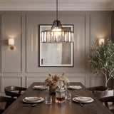 Crystal pendant light with a black frame above a set table in a panelled room
