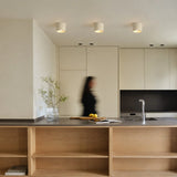 Modern cylindrical LED ceiling light with minimalist composite shade