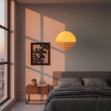 Orange dome pendant lighting a modern room from the ceiling