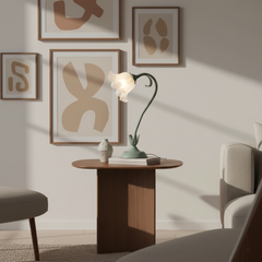 Modern flower table lamp on a walnut oval side table below framed abstract prints