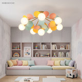 Pastel cluster ceiling light lit above a desk in a green and yellow study