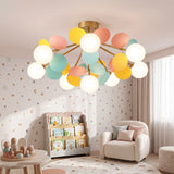 Pastel disc and globe ceiling light lit in a childrens room with soft toys
