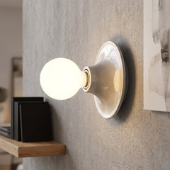 Modern flush mount wall sconce in nickel with a round white globe bulb