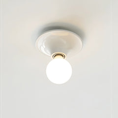 White disc ceiling light mounted flush with a globe bulb pointing down