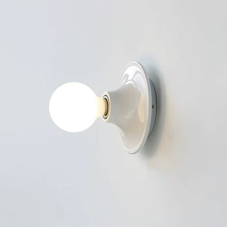 White disc wall sconce with a large lit opal globe bulb