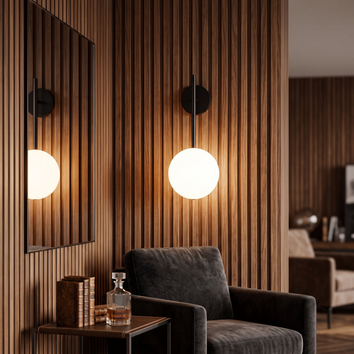 Two black globe sconces lit on a slatted timber wall beside a leather armchair