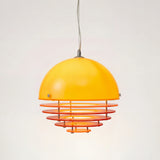 Orange glass dome pendant light with layered rings on a plain studio background