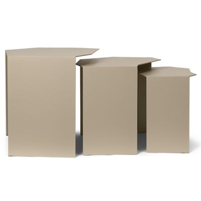 Clustered geometric metal tables styled beside modern sofa