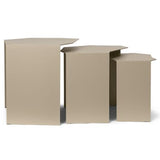 Clustered geometric metal tables styled beside modern sofa