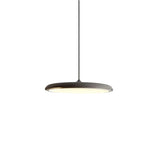 Black disc pendant light viewed at an angle showing its low flat shape