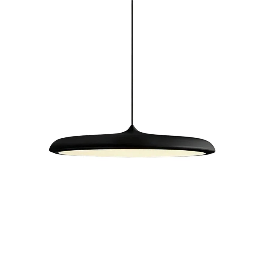 Black disc pendant light photographed straight on against a plain backdrop