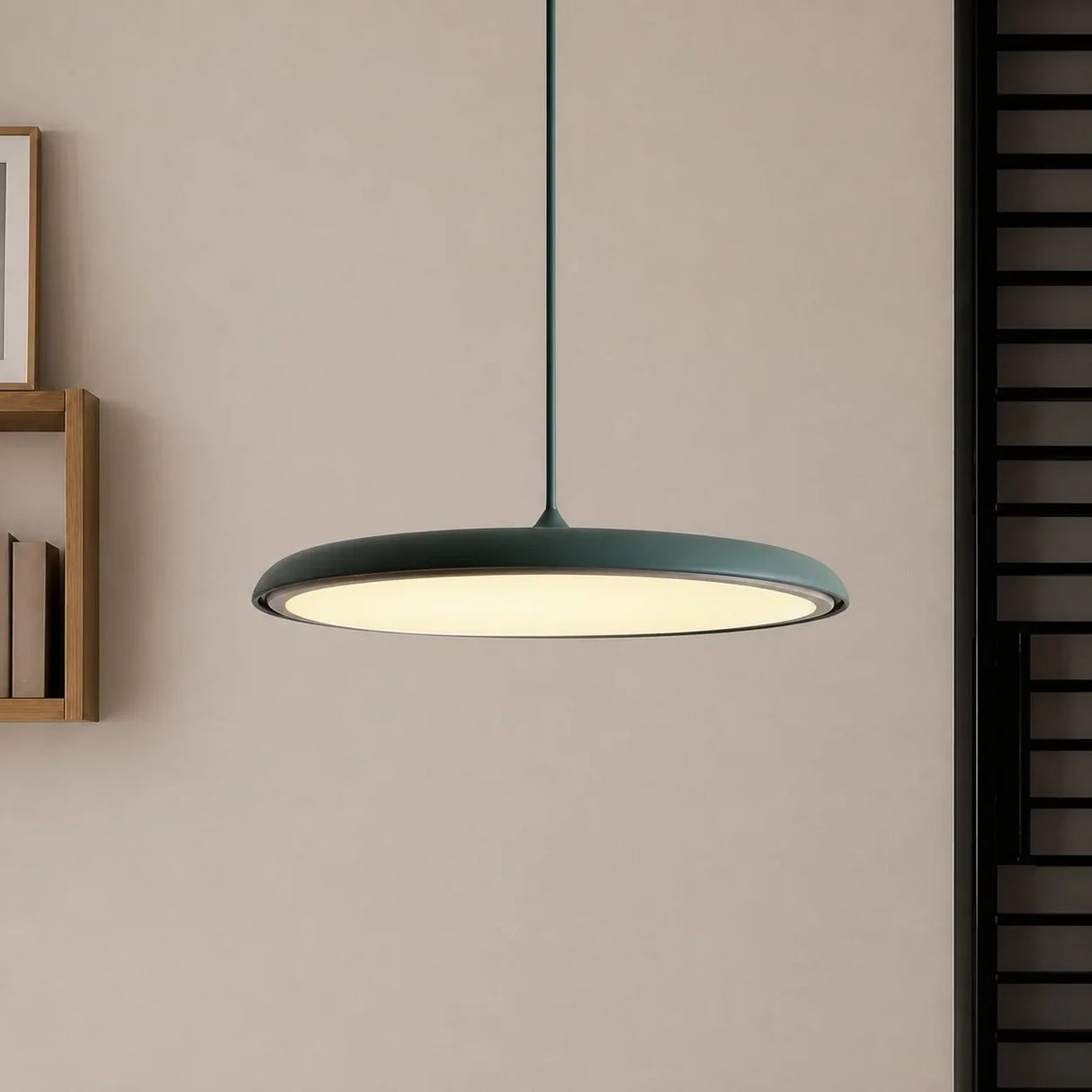 Pink disc pendant light hanging low over a neutral toned interior