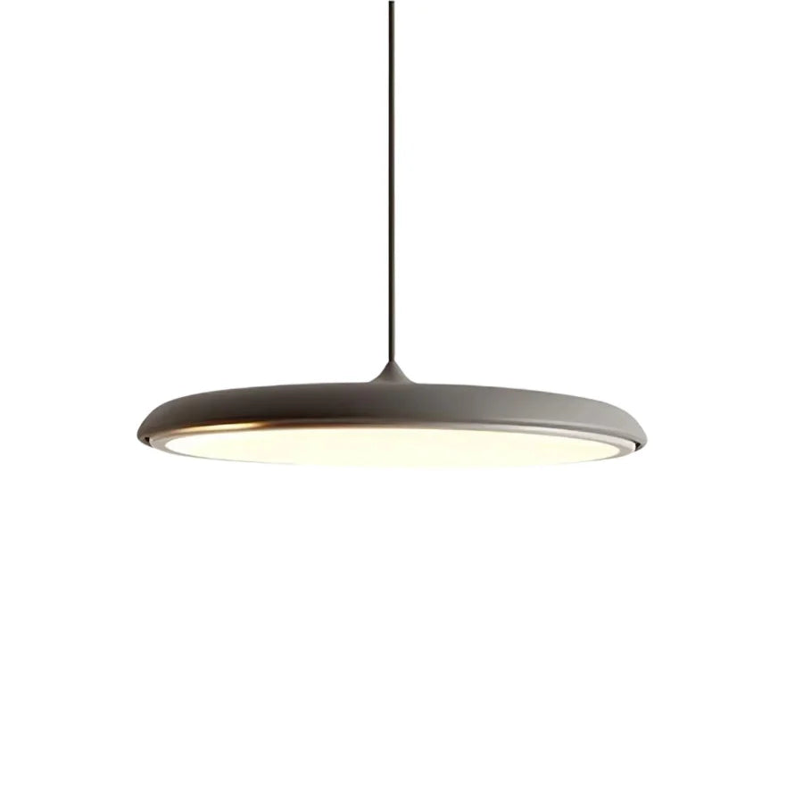 Rose gold disc pendant light seen from below with a warm even glow
