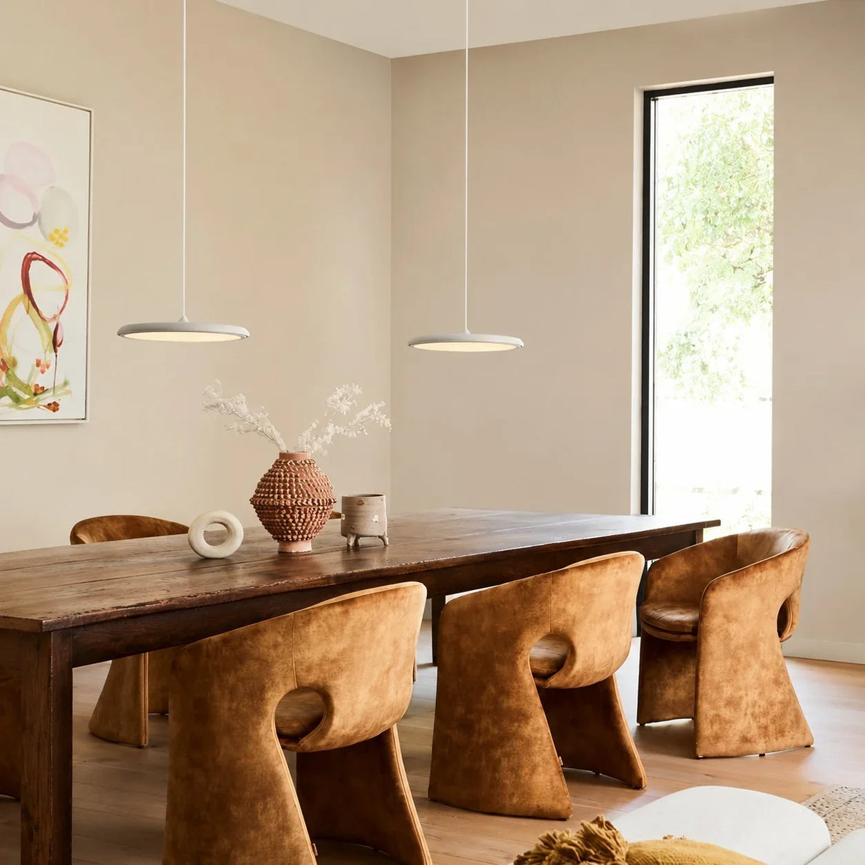 Rose gold disc pendant light with a warm metallic finish and flat shade