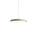 White disc pendant light photographed straight on against a plain background