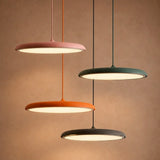 White LED disc pendant lit from below with a soft even glow