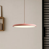 White disc pendant light seen from the side showing its slim flat profile