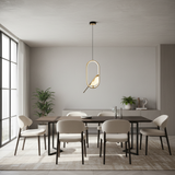 A modern dining room featuring a dark wood rectangular table with six upholstered chairs in a neutral beige and white palette, illuminated by a sleek oval pendant light hanging above.