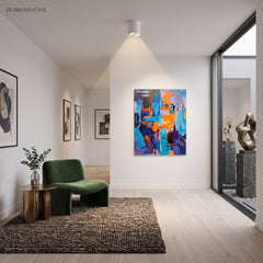White ceiling spotlight in a bright room with green armchair and rug
