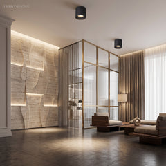 Ceiling spotlights above a living room with fluted stone feature wall